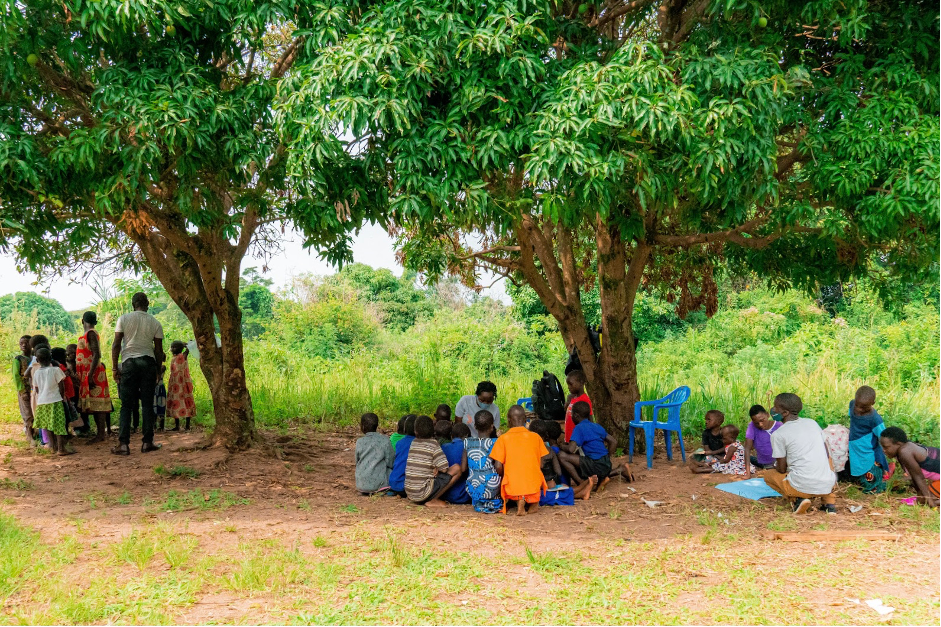 A TaRL instructor teaches children using bundles and sticks during a Roots to Rise class in Uganda.