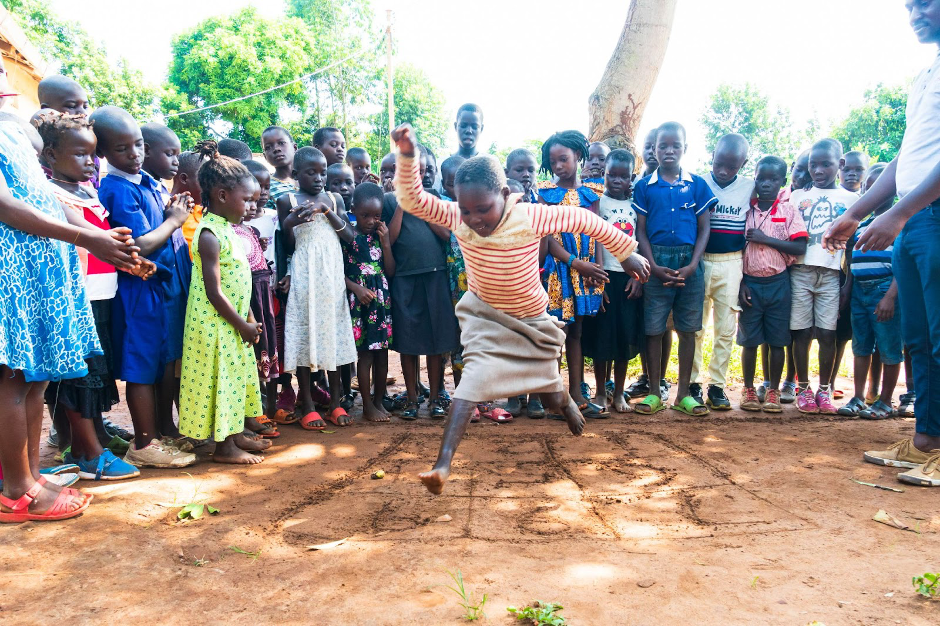 A TaRL instructor teaches children using bundles and sticks during a Roots to Rise class in Uganda.